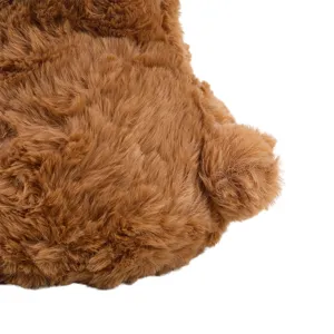 Close-up detail of soft brown plush toy bear back and fluffy tail texture, cute fluffy gift.