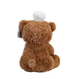 Detailed view of the cute brown plush teddy bear toy with chef hat, soft fabric and back design.