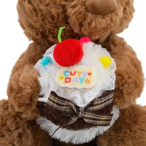 Adorable brown teddy bear plush toy holding a sweet cake with cherry and lace detail.
