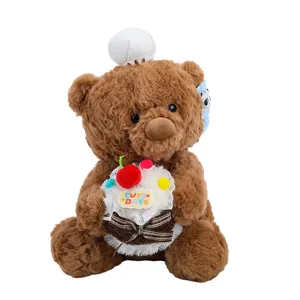 Close-up detail of the cute brown teddy bear plush toy holding a sweet cake with cherry.