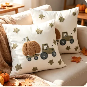 Cozy autumn pumpkin and tractor embroidered throw pillow detail showcasing textured fabric.