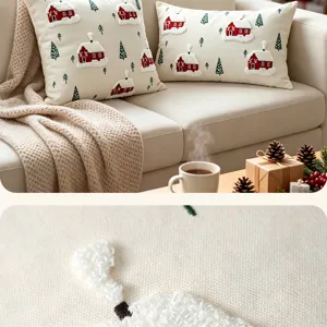 Detail shot of Christmas throw pillow cover with red house embroidery and cozy holiday home decor.
