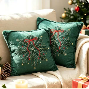 Detailed view of green Christmas embroidered throw pillow cover with snowflake and red bow design.