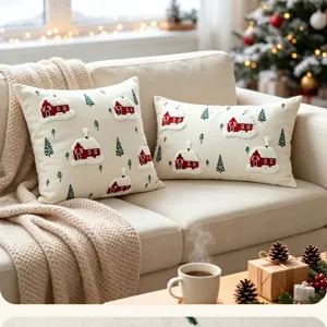 Cozy Christmas decorative pillow covers detail scene, featuring embroidered red houses and trees.