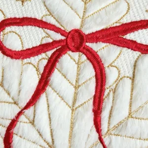 Christmas decorative pillow cover featuring red bow and gold leaf embroidery on white fur.
