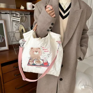 Cream quilted tote bag with cute bear embroidery and pink strap, stylish casual shoulder bag.