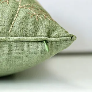 Green chenille embroidered throw pillow cover macro view, Nordic style home decor.