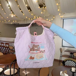 Detail view of the quilted tote bag with cute bear embroidery, soft fabric and spacious design.