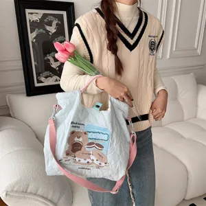 Detailed view of the cute quilted canvas tote bag with lovely bear embroidery, light blue.