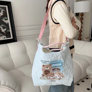 Light blue quilted shoulder bag with cute bear embroidery, spacious tote for daily use.