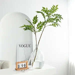 Artificial Nandina green plant in clear glass vase for home decor and interior styling.