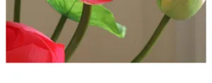 Artificial lotus flower detail close-up, vivid pink petal stem and green leaf texture.