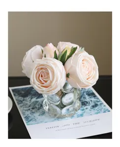 Exquisite artificial rose bouquet detail shot with transparent glass vase, elegant decor.