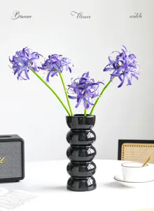 Bouquet di fiori artificiali di giglio con vaso in ceramica nera per decorazione tavola.