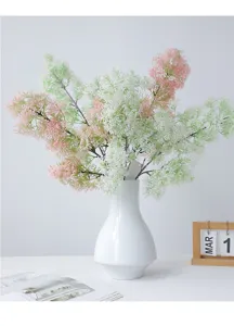 Close-up detail of artificial fuzzy grass flower bouquet in white ceramic vase for home decor.