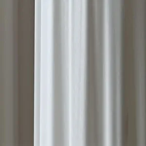 Close-up view of premium white fabric material with fine vertical texture and smooth drape.