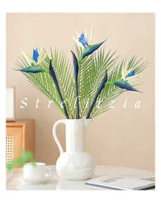 Artificial bird of paradise flowers in white vase for home decor and living room.