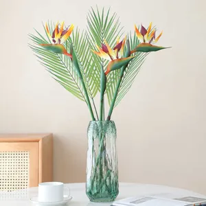 Artificial Bird of Paradise faux flower arrangement in glass vase for home decor display.