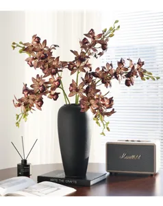 Close-up detail of artificial orchid branch flower arrangement showcasing realistic soft texture.