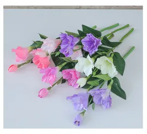 Detailed view of artificial gladiolus flowers featuring multi-color blooms and realistic green leaves.