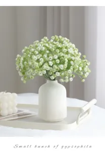 Detailed view of artificial gypsophila flower bouquet in white ceramic vase for home decor.