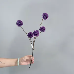 Close-up detail of artificial purple ping pong chrysanthemum branch for home decor display.