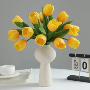 Artificial yellow tulip bouquet in white ceramic vase for home decor and wedding floral arrangement