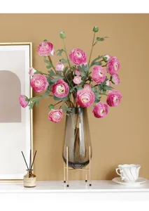 Detail shot of artificial ranunculus flower bouquet in glass vase, elegant home decor silk peony.