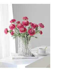 Artificial pink ranunculus flower bouquet with clear glass vase for elegant home decor.