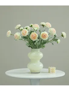 Close-up of elegant artificial flower bouquet in ceramic vase for home decor details.