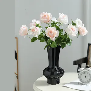 Artificial rose flower bouquet with black vase, elegant home decor table photography props.