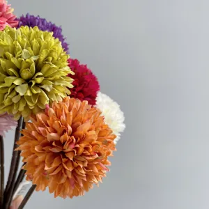 Artificial flower head close up detail, colorful pom pom chrysanthemum for home decor.