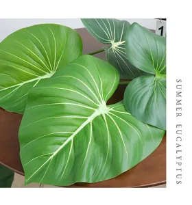 Detailed view of artificial green leaves with realistic veins, perfect for home decor.