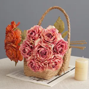 Artificial rose flower bouquet in woven basket, French vintage home decor photography props.