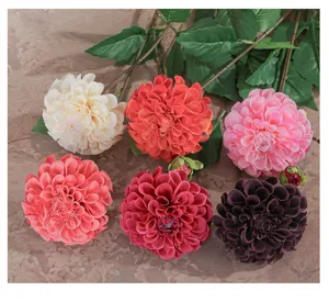Detailed view of artificial dahlia flowers with multi colors and green leaves for home decor.