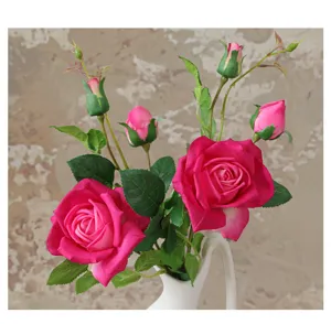 Detailed close-up of artificial pink rose flower arrangement in white vase for home decor.