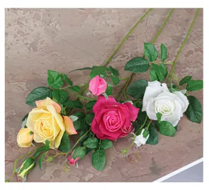 Artificial rose flowers detail shot, high simulation silk roses with long stem and green leaves.