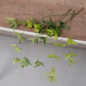 Artificial green clematis vine fake plant wall hanging decor for home wedding interior.