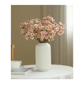Pastoral artificial flower bouquet with white ceramic vase for home dining table decor.