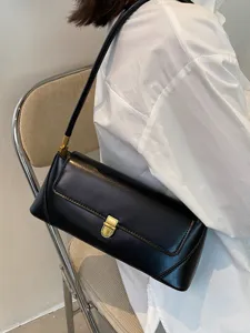 Classic black underarm baguette shoulder bag for women, vintage minimalist daily handbag.