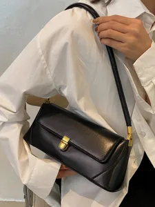 Vintage black underarm bag for women, elegant leather shoulder handbag with gold-tone hardware.