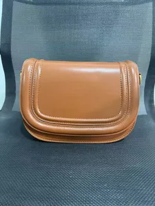 Brown leather saddle bag with flap magnetic closure and detailed stitching for women crossbody.