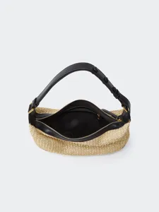 Detailed view of the woven straw hobo shoulder bag featuring black leather trim and zipper.