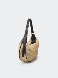 Detail view of the stylish straw hobo shoulder bag featuring black leather trim and gold hardware.