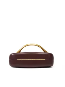 Exquisite detail view of dark brown leather box clutch bag with unique curved gold metal handle.