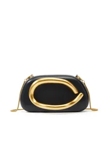 Elegant black leather box clutch bag with bold sculptural gold metal handle and chain.
