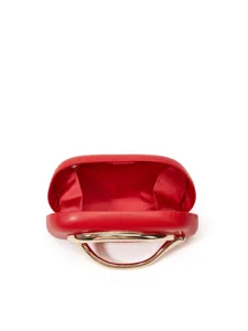 Detail view of the red box clutch bag featuring a sleek gold metal handle and lining.