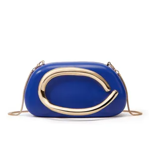 Detail view of the mini blue crossbody box bag featuring a statement gold metallic C handle.