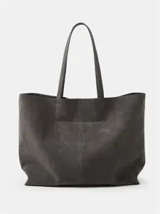 Dark grey suede tote bag detail, featuring fine vertical seam and smooth texture.