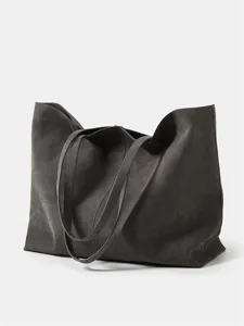 Large capacity dark grey leather tote bag detail, featuring soft slouchy silhouette and twin handles.